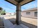 Covered front porch with a view of the neighborhood street and xeriscaped landscaping at 8861 W Paradise Dr, Peoria, AZ 85345