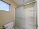 Bathroom featuring a shower with glass doors, white tile, and functional fixtures at 8861 W Paradise Dr, Peoria, AZ 85345