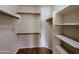 Walk-in closet with built-in shelving and wood floors; providing excellent storage solutions at 8861 W Paradise Dr, Peoria, AZ 85345