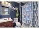 Bathroom with blue walls featuring a dark wood vanity, toilet, and shower with curtain at 910 W Aspen Way, Gilbert, AZ 85233