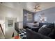 Stylish bedroom featuring a bed, dark dresser, couch, and hardwood floors, shot from the landing at 910 W Aspen Way, Gilbert, AZ 85233