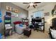 Comfortable bedroom featuring a chair, desk, and shelving unit at 910 W Aspen Way, Gilbert, AZ 85233