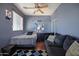 Stylish bedroom featuring a bed, dark dresser, couch, and hardwood floors at 910 W Aspen Way, Gilbert, AZ 85233