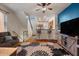 Inviting living room with hardwood floors, bold blue accent wall, and adjacent kitchen and staircase at 910 W Aspen Way, Gilbert, AZ 85233