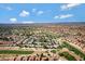 Vast aerial perspective of a community adjacent to a golf course featuring well-maintained greens and fairways at 9115 W Kimberly Way, Peoria, AZ 85382