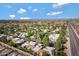 Expansive aerial view of the residential neighborhood, showcasing mature landscaping and a major throughfare at 9115 W Kimberly Way, Peoria, AZ 85382