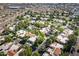 Scenic aerial view of a neighborhood showcasing homes with terra cotta tile roofs and verdant landscaping at 9115 W Kimberly Way, Peoria, AZ 85382