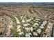 Expansive aerial view of a community with tile-roofed homes, a golf course, and desert landscape at 9115 W Kimberly Way, Peoria, AZ 85382