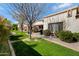 Grassy backyard with a covered patio, ideal for outdoor relaxation and activities at 9115 W Kimberly Way, Peoria, AZ 85382