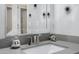 Close up shot of bathroom sink and mirror, with white cabinets and decorative accents at 9115 W Kimberly Way, Peoria, AZ 85382