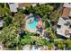 Overhead view of community pool area featuring lush greenery, lounge chairs, and shade at 9115 W Kimberly Way, Peoria, AZ 85382