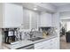 Well-lit kitchen with a large sink, modern fixtures, ample counter space and white shaker cabinets at 9115 W Kimberly Way, Peoria, AZ 85382