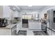 Bright kitchen with modern appliances, light gray counters, and a view into the open-plan living area at 9115 W Kimberly Way, Peoria, AZ 85382