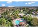 Aerial view of a pristine pool with a covered seating area surrounded by palm trees in a lush community at 9115 W Kimberly Way, Peoria, AZ 85382