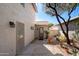 Inviting backyard with stone pavers, mature trees, and a secure gated entrance to the property at 9224 E Windrose Dr, Scottsdale, AZ 85260