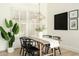 Modern dining room with wooden table, black chairs, and stylish decor at 9224 E Windrose Dr, Scottsdale, AZ 85260