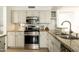 Well-equipped kitchen with stainless steel appliances and granite countertops at 9224 E Windrose Dr, Scottsdale, AZ 85260