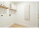 Clean, white laundry room featuring storage cabinets and hookups at 9224 E Windrose Dr, Scottsdale, AZ 85260