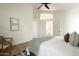 Light-filled main bedroom with wood floors and neutral decor at 9224 E Windrose Dr, Scottsdale, AZ 85260