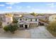 Stunning aerial view of two story home, landscaped yard and mountain backdrop at 925 E Doris St, Avondale, AZ 85323