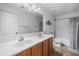 Bathroom with a double sink vanity, tiled floors, and shower-tub combination at 925 E Doris St, Avondale, AZ 85323