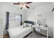 Cozy bedroom with plush carpeting, window with natural light, and a vanity desk setup at 925 E Doris St, Avondale, AZ 85323