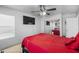 Bedroom featuring mounted TV, ceiling fan, and large closet with mirrored doors at 925 E Doris St, Avondale, AZ 85323