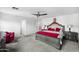 Bright bedroom featuring a ceiling fan, soft carpet, and an ornate bed frame with red accents at 925 E Doris St, Avondale, AZ 85323