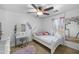 Cozy bedroom with vanity, plush carpet, and large sunny window at 925 E Doris St, Avondale, AZ 85323