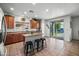 Bright, open-concept kitchen with wood cabinets, tile flooring, and a breakfast bar at 925 E Doris St, Avondale, AZ 85323