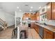 Bright kitchen with stainless steel appliances and island with breakfast bar, seamlessly connecting with other living spaces at 925 E Doris St, Avondale, AZ 85323