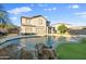 Beautiful backyard pool with waterfall feature and manicured landscaping at 925 E Doris St, Avondale, AZ 85323