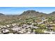 Panoramic view of the neighborhood featuring varied architectural styles, desert vegetation, and the backdrop of rugged mountains at 9430 N 25Th St, Phoenix, AZ 85028