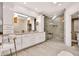 Luxurious primary bathroom featuring a double sink vanity and a frameless glass shower with a built-in bench at 9430 N 25Th St, Phoenix, AZ 85028