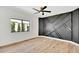 Bedroom with modern accent wall, ceiling fan and bright window view at 9430 N 25Th St, Phoenix, AZ 85028