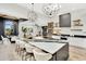 Modern kitchen featuring a large island with seating, stylish pendant lighting, and stainless steel appliances at 9430 N 25Th St, Phoenix, AZ 85028