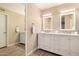 Elegant bathroom featuring dual sinks, marble countertops, and stylish white cabinetry at 9460 N 92Nd St # 119, Scottsdale, AZ 85258