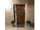 Inviting front door with green wreath and green accent plants at 9460 N 92Nd St # 119, Scottsdale, AZ 85258