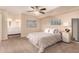 Spacious main bedroom with en-suite bathroom, a ceiling fan, and neutral decor at 9460 N 92Nd St # 119, Scottsdale, AZ 85258