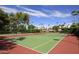 Tennis court with manicured landscaping, and community buildings in the background at 9460 N 92Nd St # 119, Scottsdale, AZ 85258