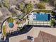 Aerial view of a backyard featuring a pool, hot tub, tiled patios, desert landscaping and luxurious outdoor living spaces at 10040 E Happy Valley Rd # 289, Scottsdale, AZ 85255