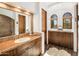 An amazing bathroom features tile countertops and backsplash with beautiful wood cabinets and an arched doorway at 10040 E Happy Valley Rd # 289, Scottsdale, AZ 85255