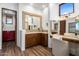 Well-lit bathroom with wooden cabinetry, granite countertops, and a vanity area at 10040 E Happy Valley Rd # 289, Scottsdale, AZ 85255