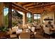 Elegant dining area with desert views, decorative chandelier, and stone fireplace at 10040 E Happy Valley Rd # 289, Scottsdale, AZ 85255