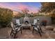 Cozy outdoor fireplace setting with comfortable chairs, perfect for enjoying evening gatherings at 10040 E Happy Valley Rd # 289, Scottsdale, AZ 85255