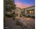 Beautiful front entrance featuring a circular foyer with a stone walkway and lush desert landscaping at 10040 E Happy Valley Rd # 289, Scottsdale, AZ 85255