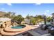 Secluded backyard hot tub with a rock waterfall feature and desert landscaping, offering a private and tranquil retreat at 10040 E Happy Valley Rd # 289, Scottsdale, AZ 85255