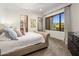 Comfortable main bedroom with a large window, neutral paint, and views of the lush backyard at 10040 E Happy Valley Rd # 289, Scottsdale, AZ 85255