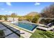 Relaxing backyard pool with lounge chairs, waterfall feature and desert landscaping that offers a private resort-like experience at 10040 E Happy Valley Rd # 289, Scottsdale, AZ 85255