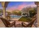 Scenic pool area with comfortable lounge chairs and views of a majestic mountain at sunset at 10040 E Happy Valley Rd # 289, Scottsdale, AZ 85255